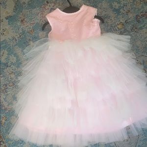 A beautiful pink ruffled flower girl dress.